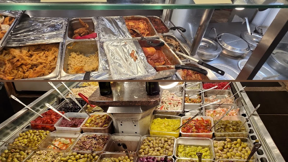 Prepared food trays line a buffet service area.